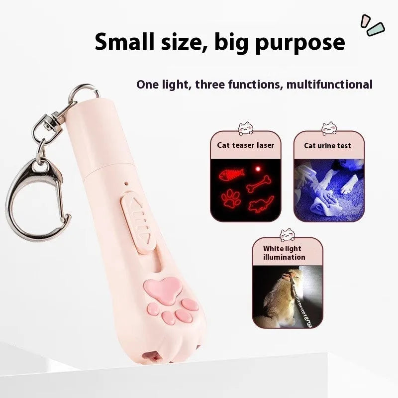 Pink self-playing cat teaser wand toy with USB charging cable on a table.