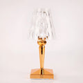 Rose gold portable touch projection night light with dimming controls on acrylic base.