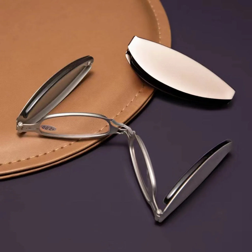 Man's folding pocket presbyopic glasses with retro ring frame in black, shown open and folded.