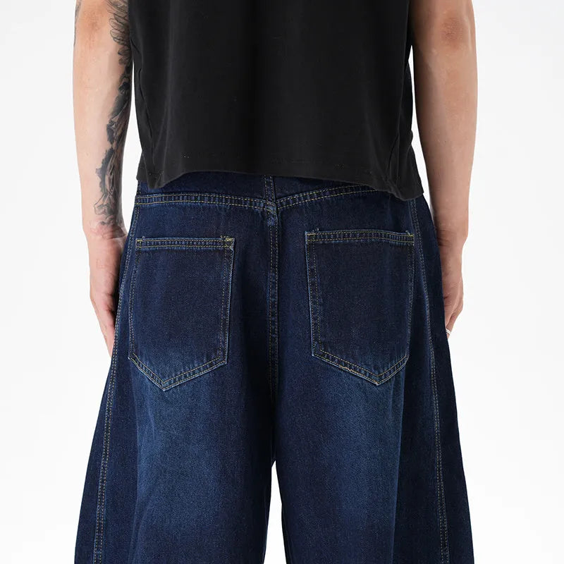 Dark blue wide leg women's jeans with a machete cut and distressed detailing on denim fabric.