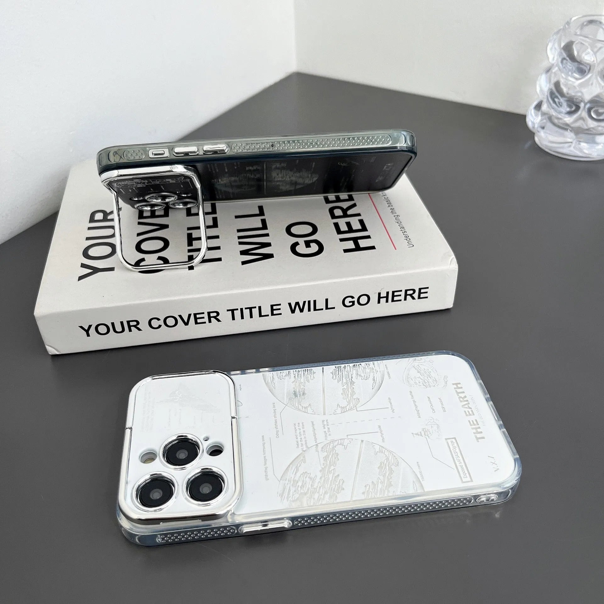 Pleated bracket TPU phone case with metal planet design for iPhone 14 Pro, two colour options shown