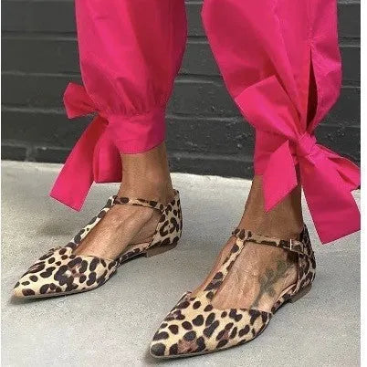 Women's leopard print pointed toe pumps with a short chunky heel and ankle strap.