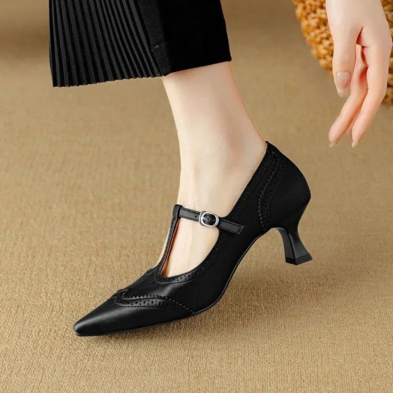 Women's black high heel pump with vintage skull engraving and stiletto heel.