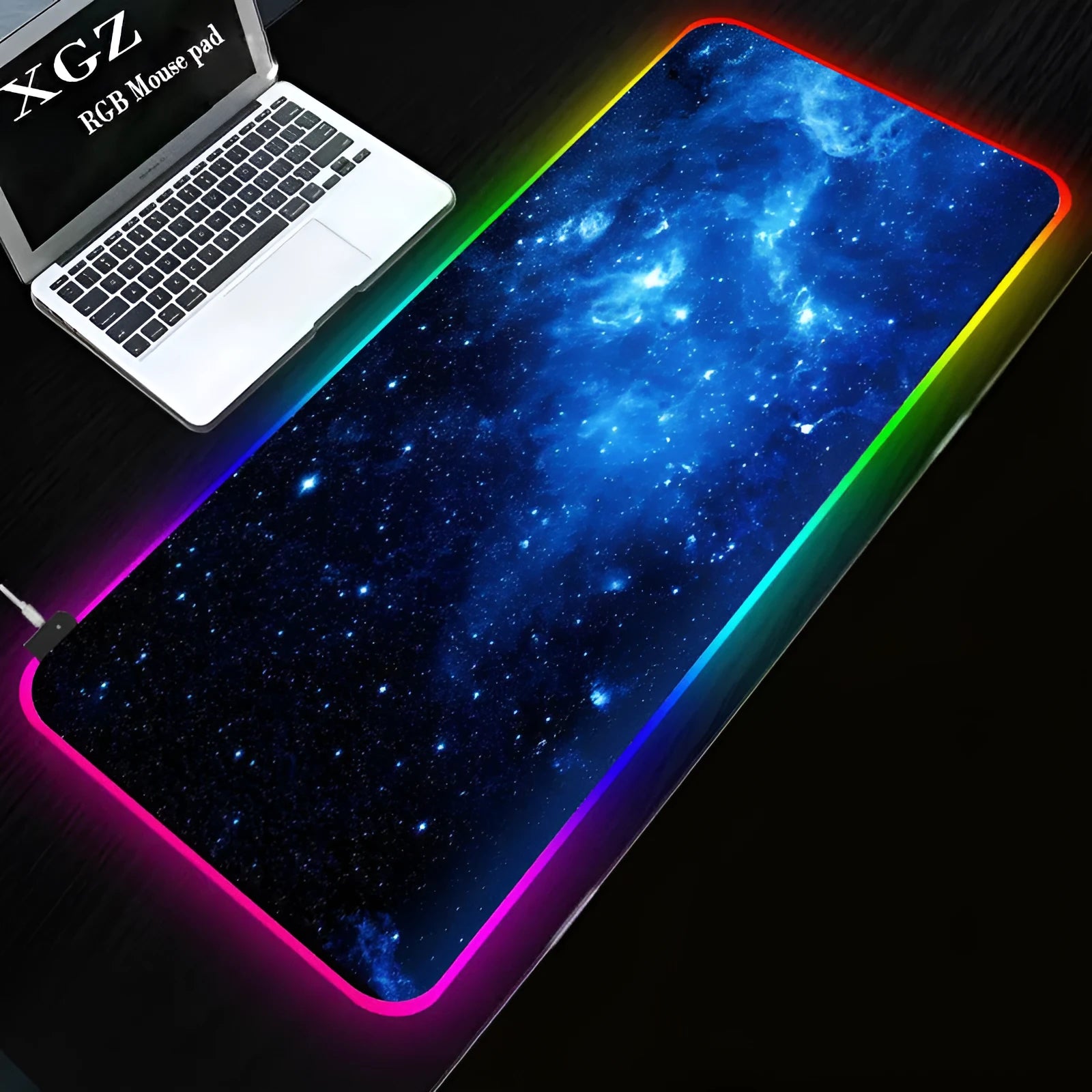 Symphony RGB luminous gaming mouse pad with starry sky pattern on a desk, showing USB cable.