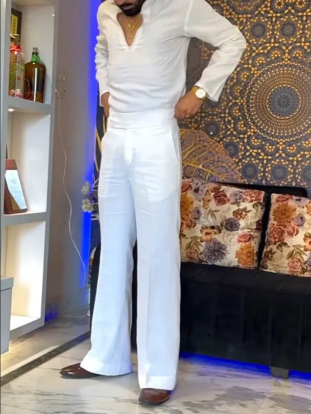 White three-piece outfit set showing V-neck shirt, sleeveless vest, and trousers laid flat