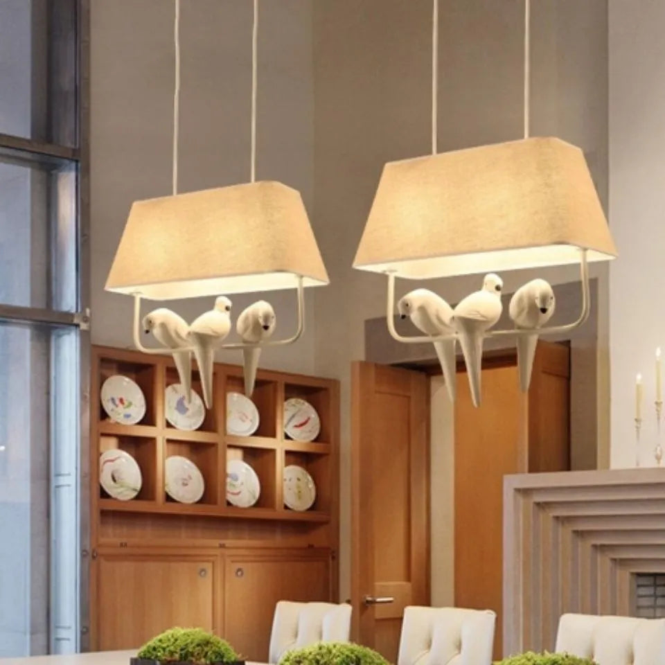 Bird chandelier ceiling lamp with iron frame and fabric shade in dining room setting