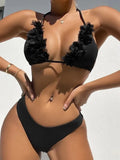 Black women's bikini set with gathered ruffle detail on top and matching shorts