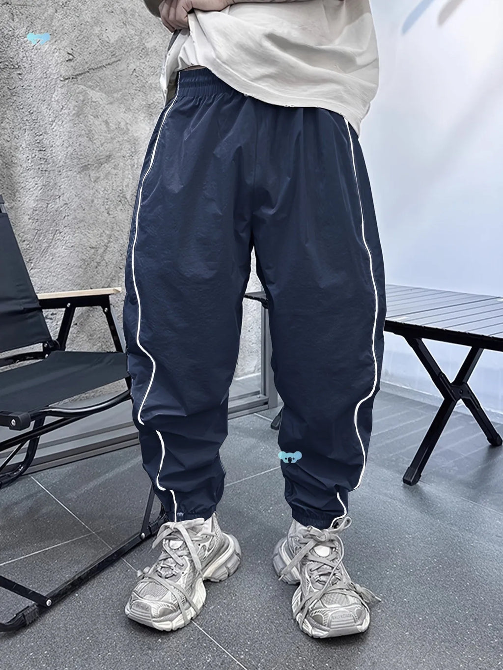 Men's blue bamboo fibre cropped casual sports trousers on a hanger.