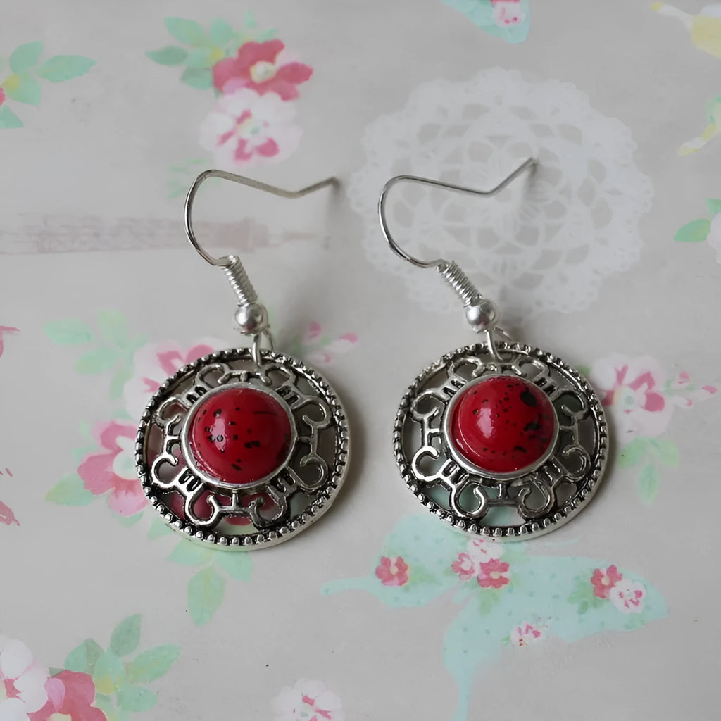 Handmade Miao-inspired silver and turquoise geometric flower disk earrings in black, blue, and red.