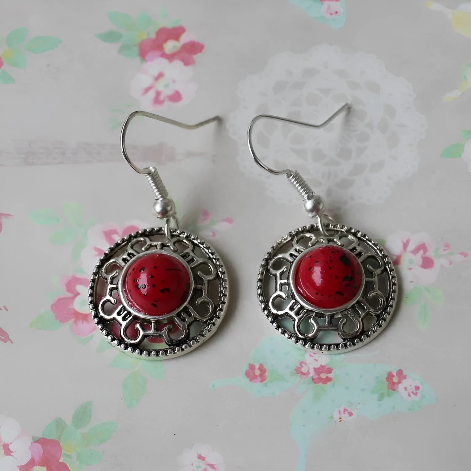 Handmade Miao-inspired silver and turquoise geometric flower disk earrings in black, blue, and red.