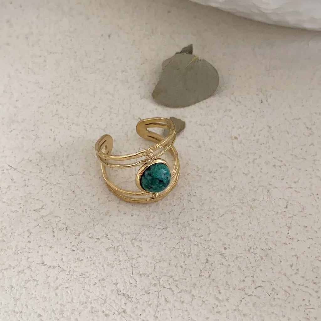 Geometric open ring with a green natural stone set on a titanium steel electroplated band.