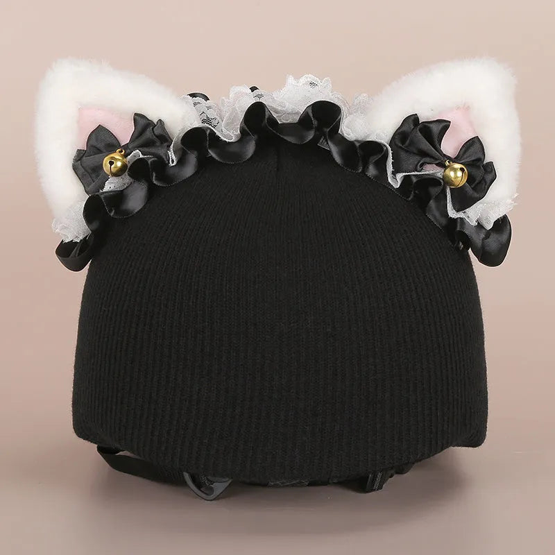 Plush fabric cartoon character decoration cover placed on a ski helmet.