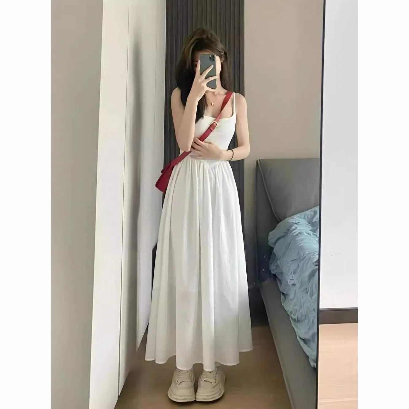 A-line slip dress in black with wide waist and sleeveless design made from polyester