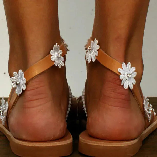 Brown women's Roman sandals with floral decoration and herringbone toe pattern