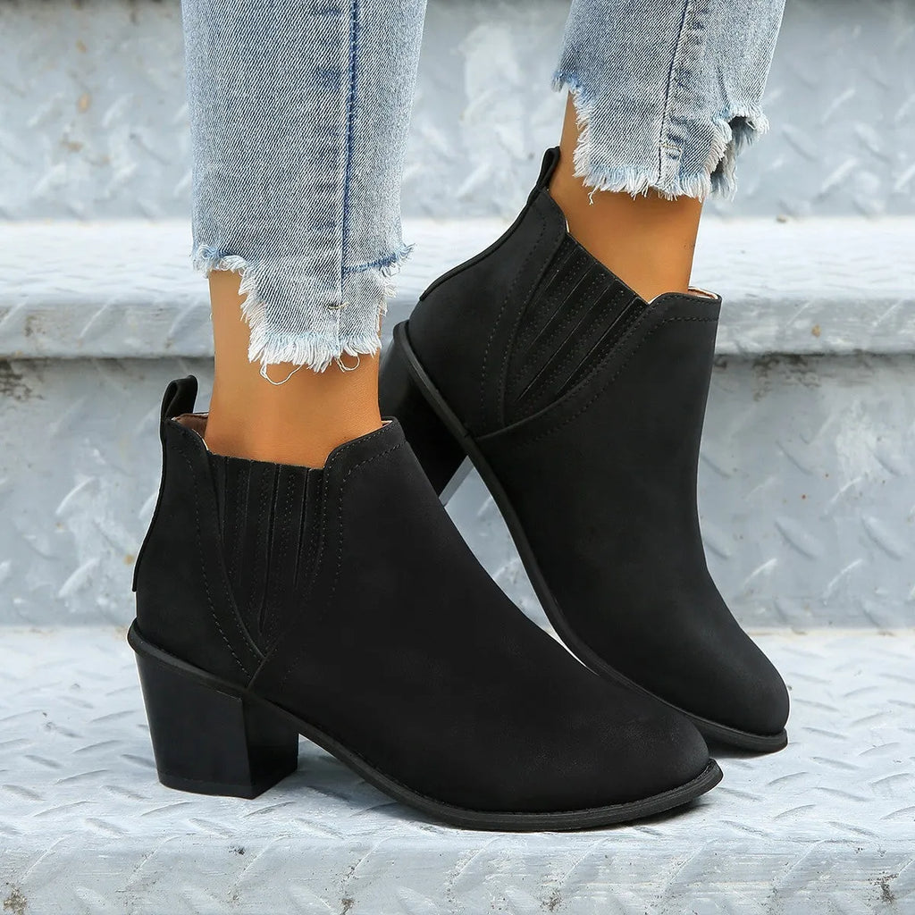 Women's black pointed toe ankle boots with a thick square low heel, made of artificial PU.