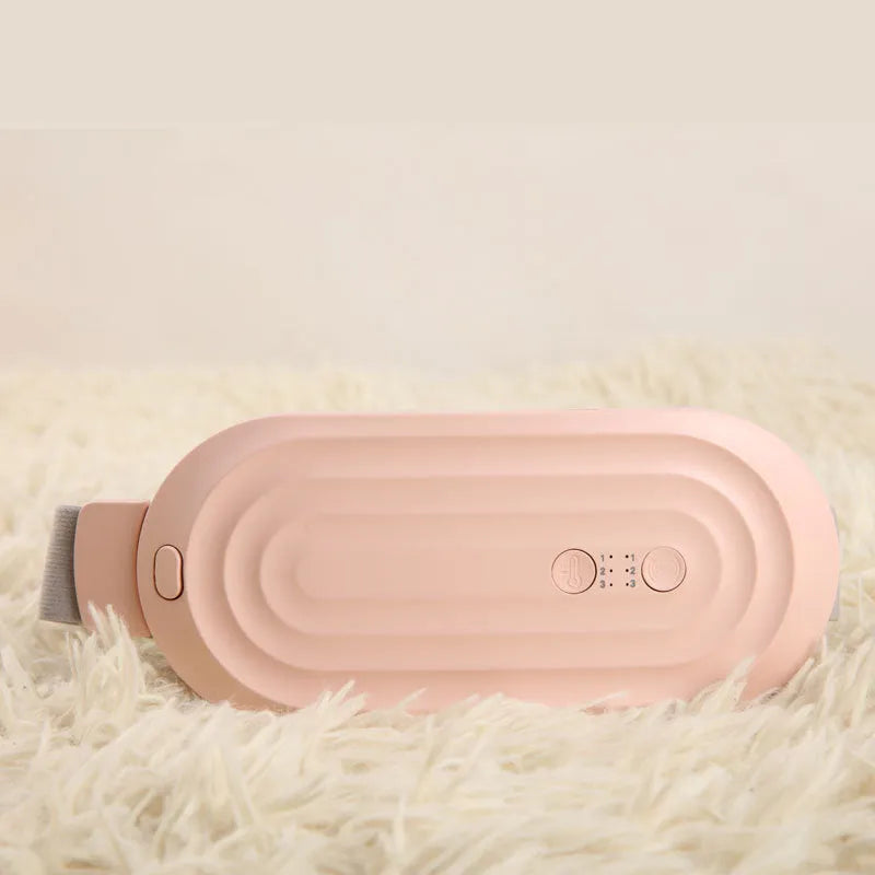 Pink menstrual heating pad with controller displaying temperature settings and vibration options