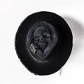 Handmade wool felt skull hat with a conical crown and blue denim trim.
