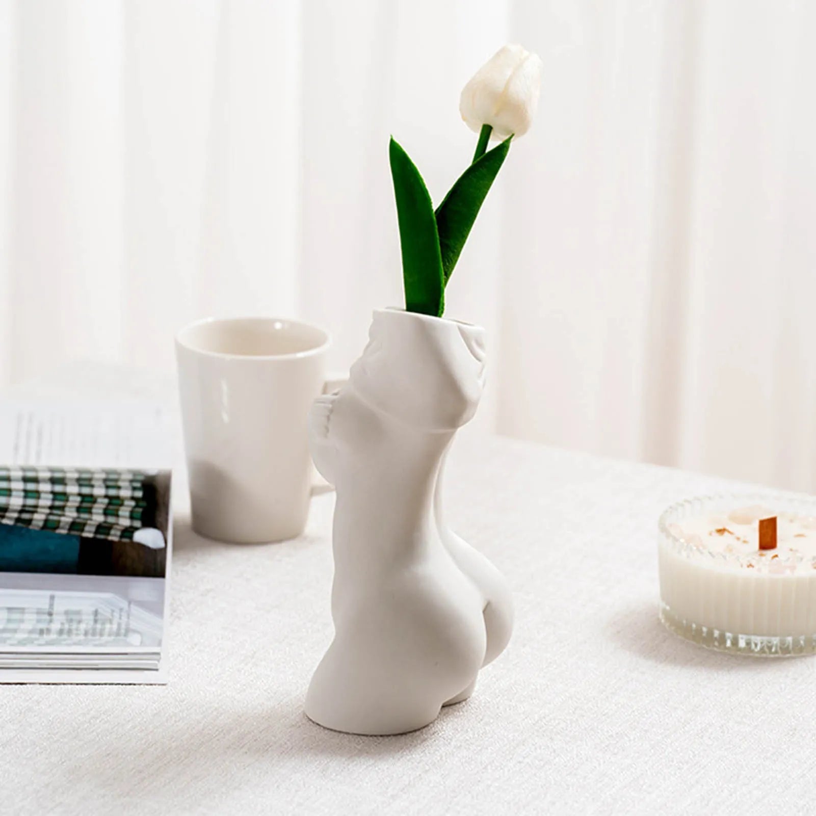 White porcelain figurative human vase with 21.2cm height on a shelf