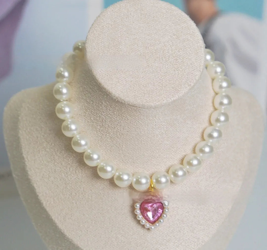 Cat collar with plastic heart charm in blue, shown alongside pink, green, purple, transparent and sapphire blue colour options