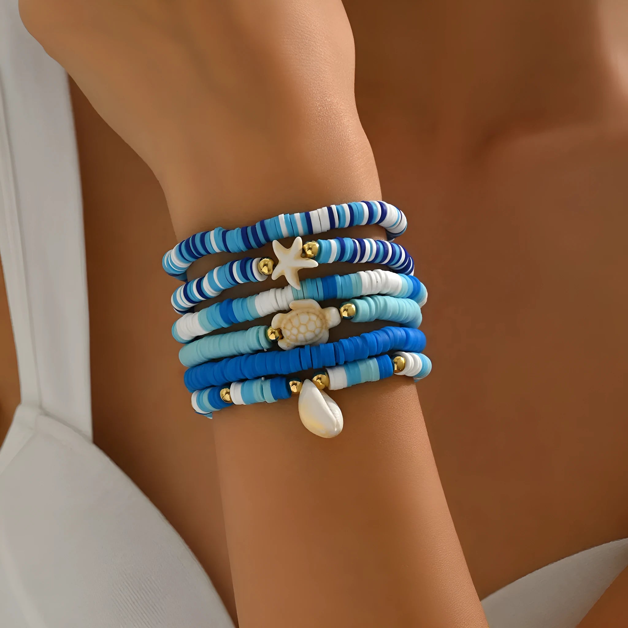 Set of six handmade geometric shell bracelets in Bohemian blue polymer clay.