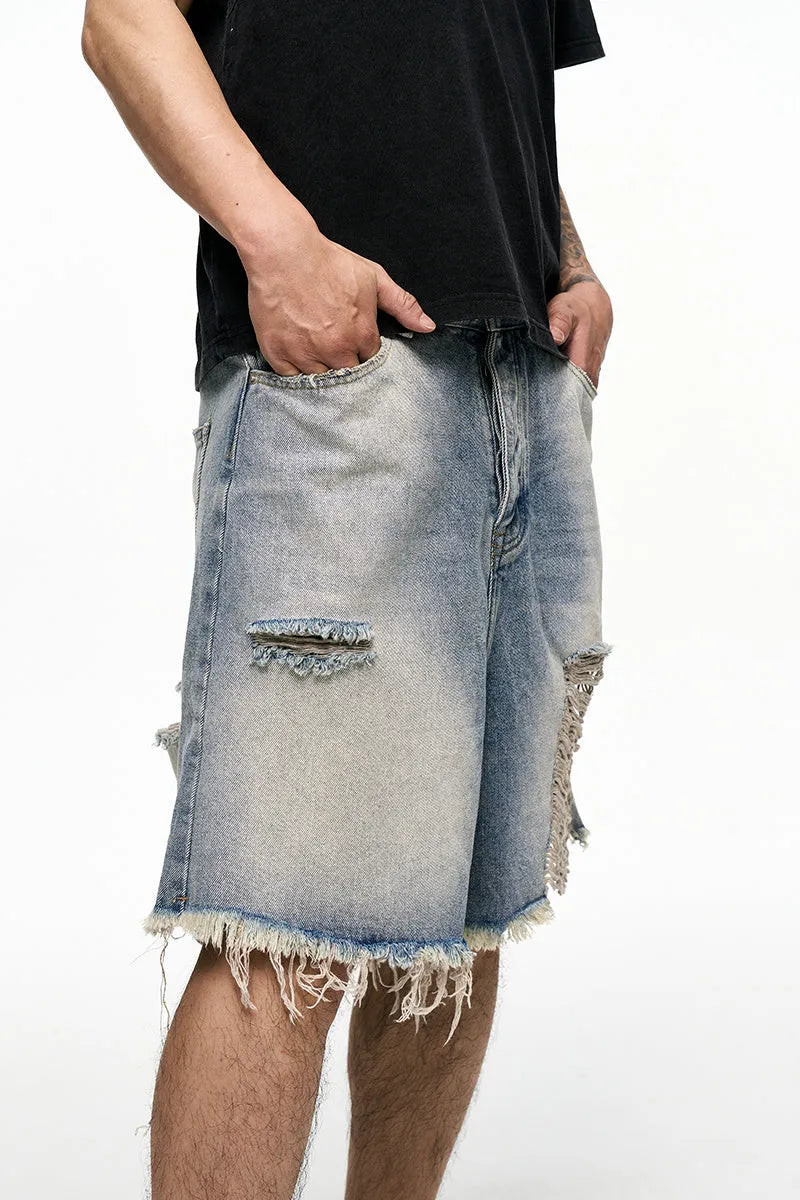Light blue men's baggy denim shorts with a wide leg cut and mid waist on a plain background