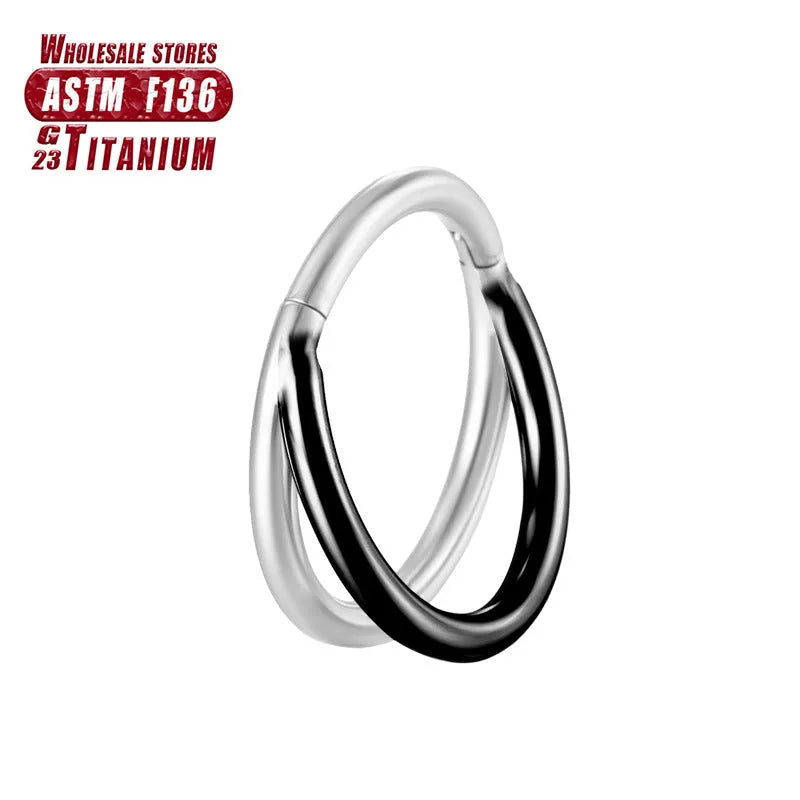 Titanium alloy nose ring body jewellery in silver colour on a plain background.