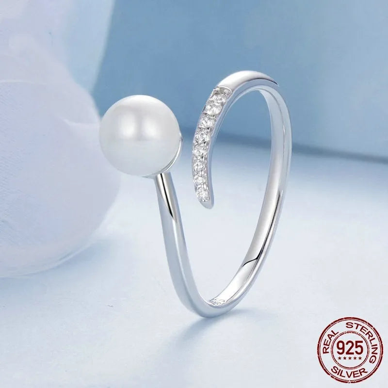 S925 sterling silver adjustable ring with shell pearl accents showing open loop design
