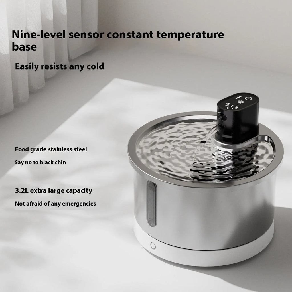 White cat water fountain with stainless steel dish and digital temperature control base on a wooden floor.