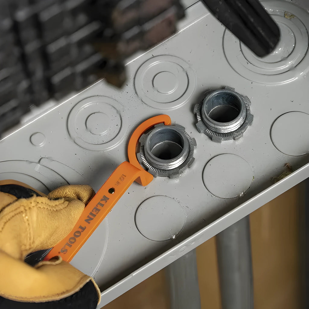 Three colour-coded wrenches in orange, grey and black showing crescent, magnetic and catheter locking designs