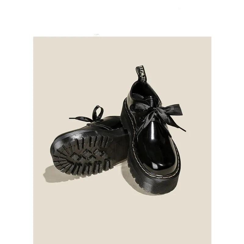 Black thick soled women's lace-up shoes with ribbon and cross strap details on superfine fibre upper