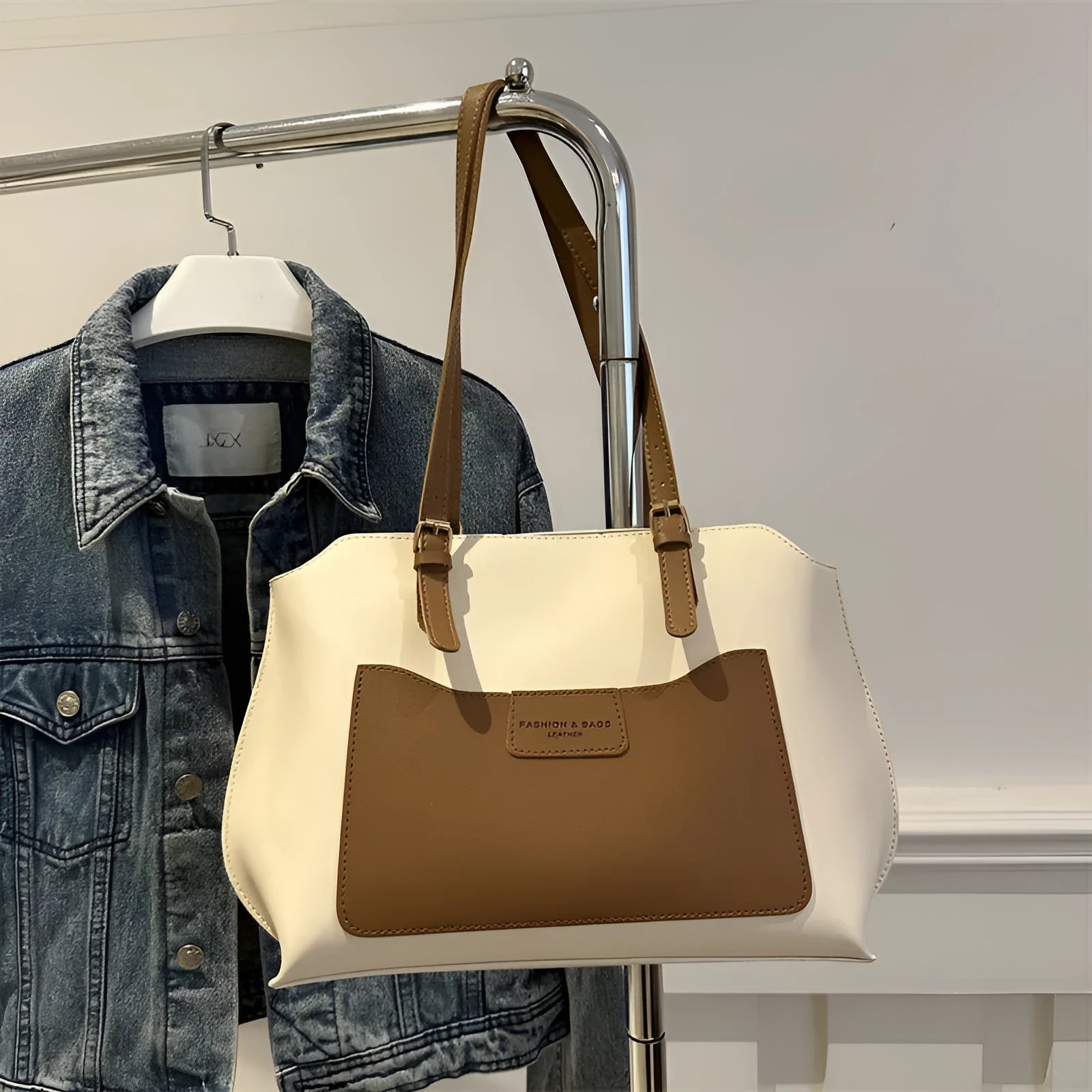 Women's black PU tote bag with shoulder straps showing internal mobile phone pocket