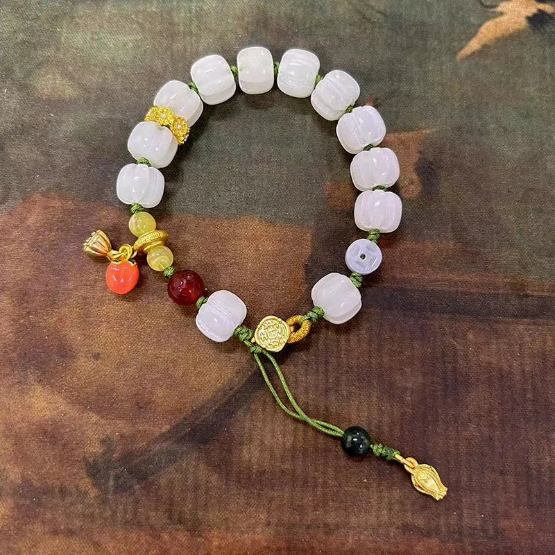 Hand-woven white jade bodhi bracelet showing pumpkin and lotus beads on adjustable open rope