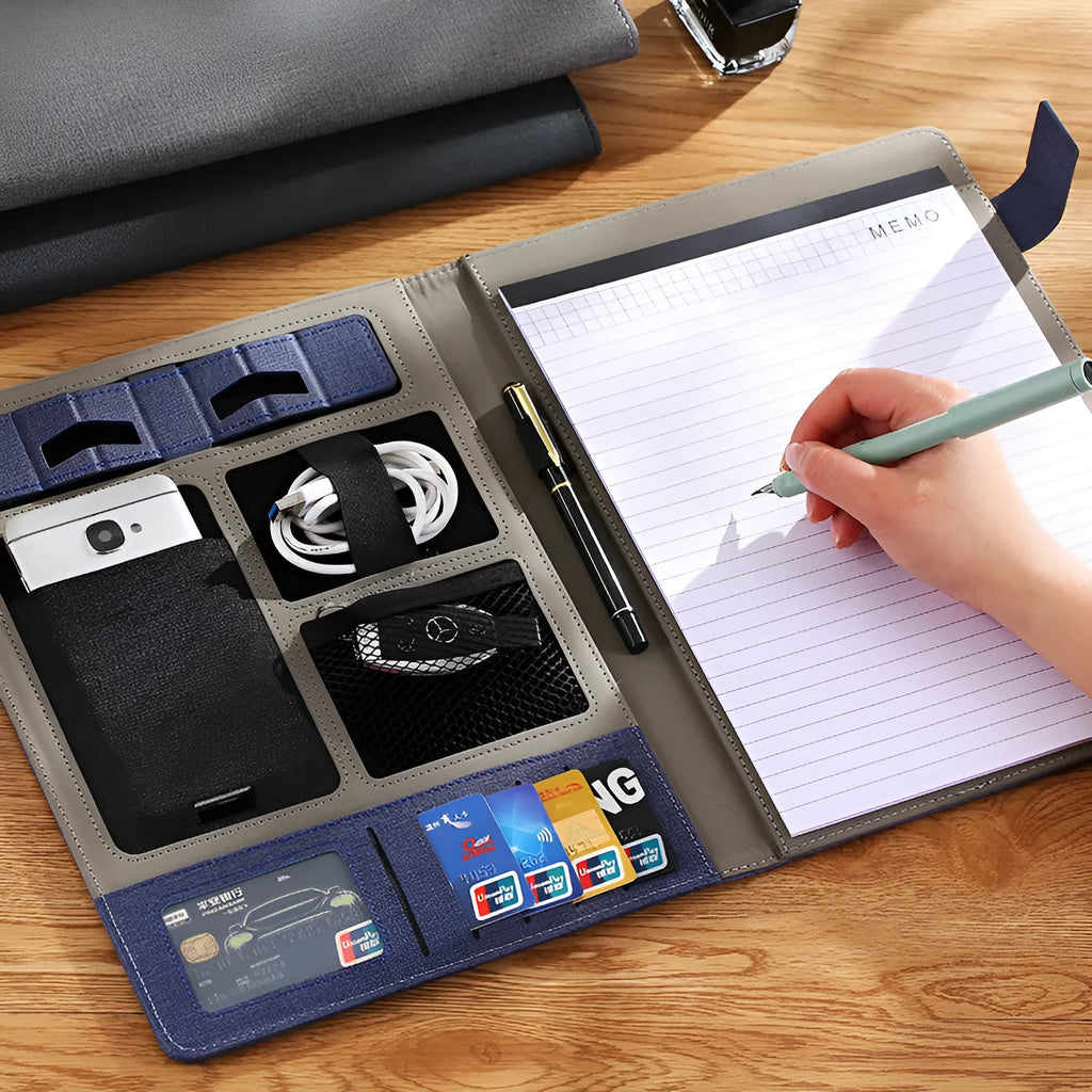 Black leather A4 business folder holding documents, shown alongside pen and notepad.