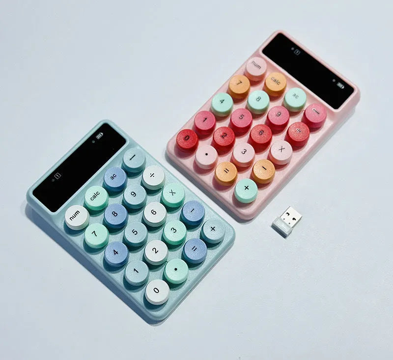 Mini portable wireless keyboard in a macaron colour option on a desk.