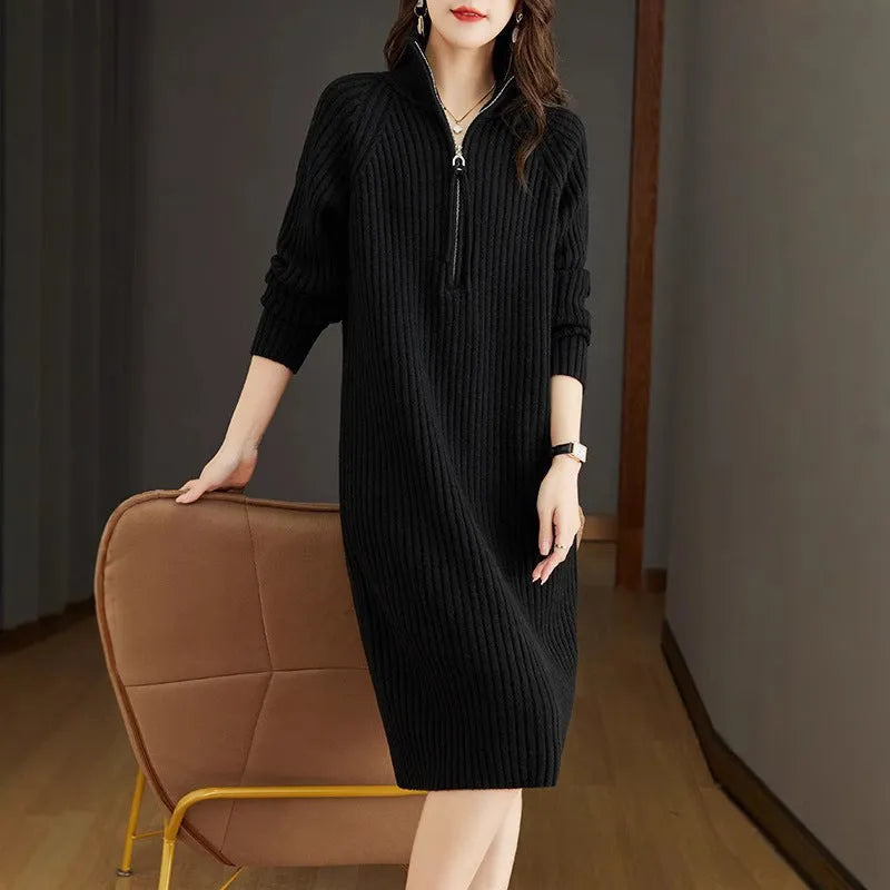 Beige half-zip woolen skirt with stand collar and long sleeves in a loose, straight dress cut.