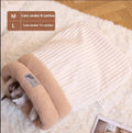 Brown plush semi-enclosed cat sleeping bag with thick stripes, shown on a floor.