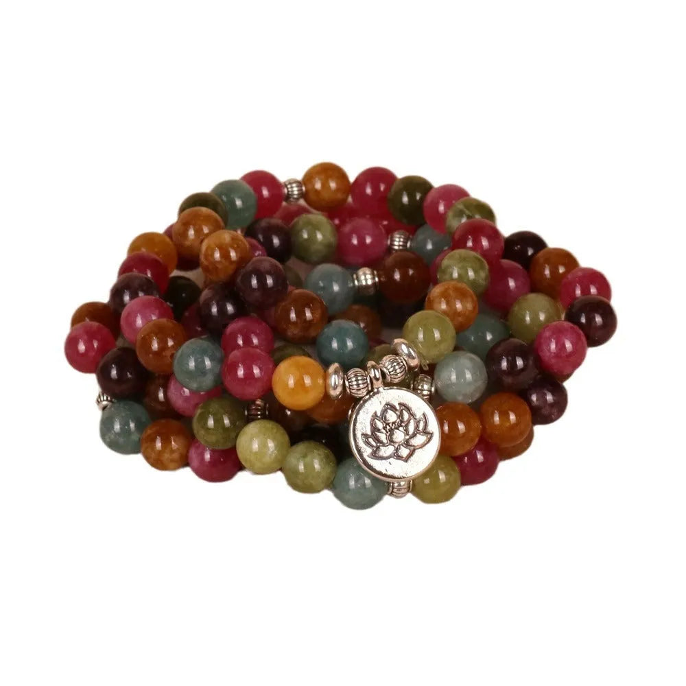 Tourmaline-colour alloy bracelet with 108 beads in a lotus string design laid flat