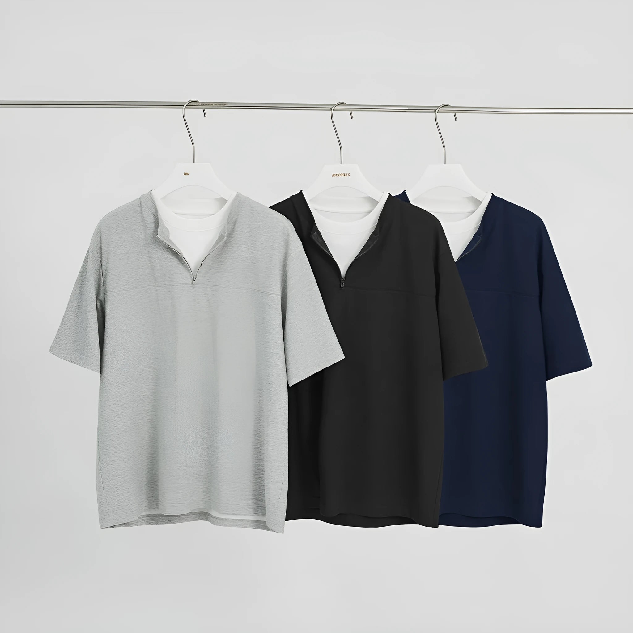 A loose blue cotton blend pullover top with a false zip and patchwork collage stitching detail.
