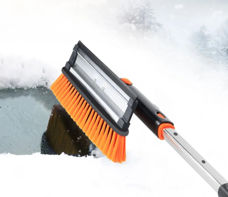 Car snow plough shovel set with plastic shovel, brush, telescopic rod, and frost scraper on a snowy car windscreen