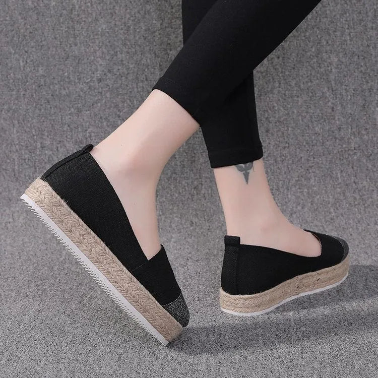 Plus size beige and black breathable canvas flat shoes with round toe and slip-on design.