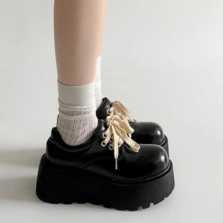 Women's matte black lace-up platform ankle boots with a thick sole and round toe.