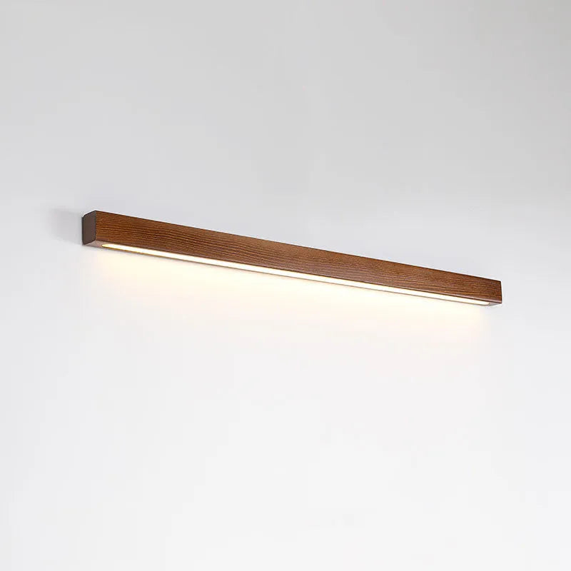 Walnut colour wood and acrylic log strip wall lamp in three lengths with integrated LED lighting