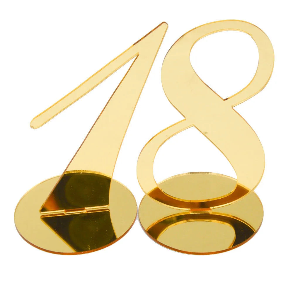 Clear acrylic table number holder with gold base displaying number 1 on a table