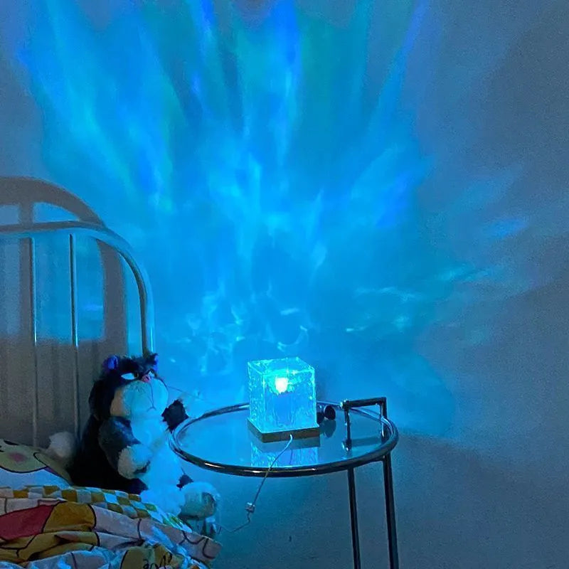 Water ripple crystal table lamp projecting coloured light patterns on wall