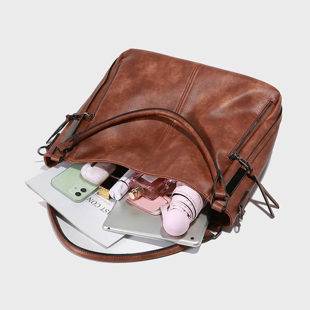 Soft PU crossbody shoulder bag in khaki with metal accent and double strap connectors on a white background