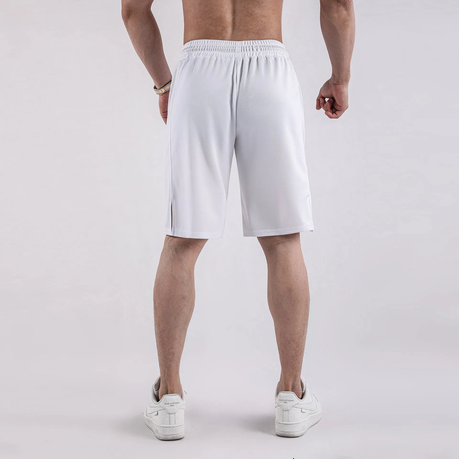 Man wearing black loose-fit quick-dry mesh shorts with an elasticated waistband.