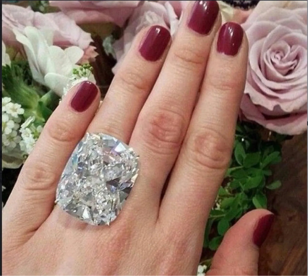 A women's simple inlaid white square diamond ring with a geometric shape and white gold colour finish.