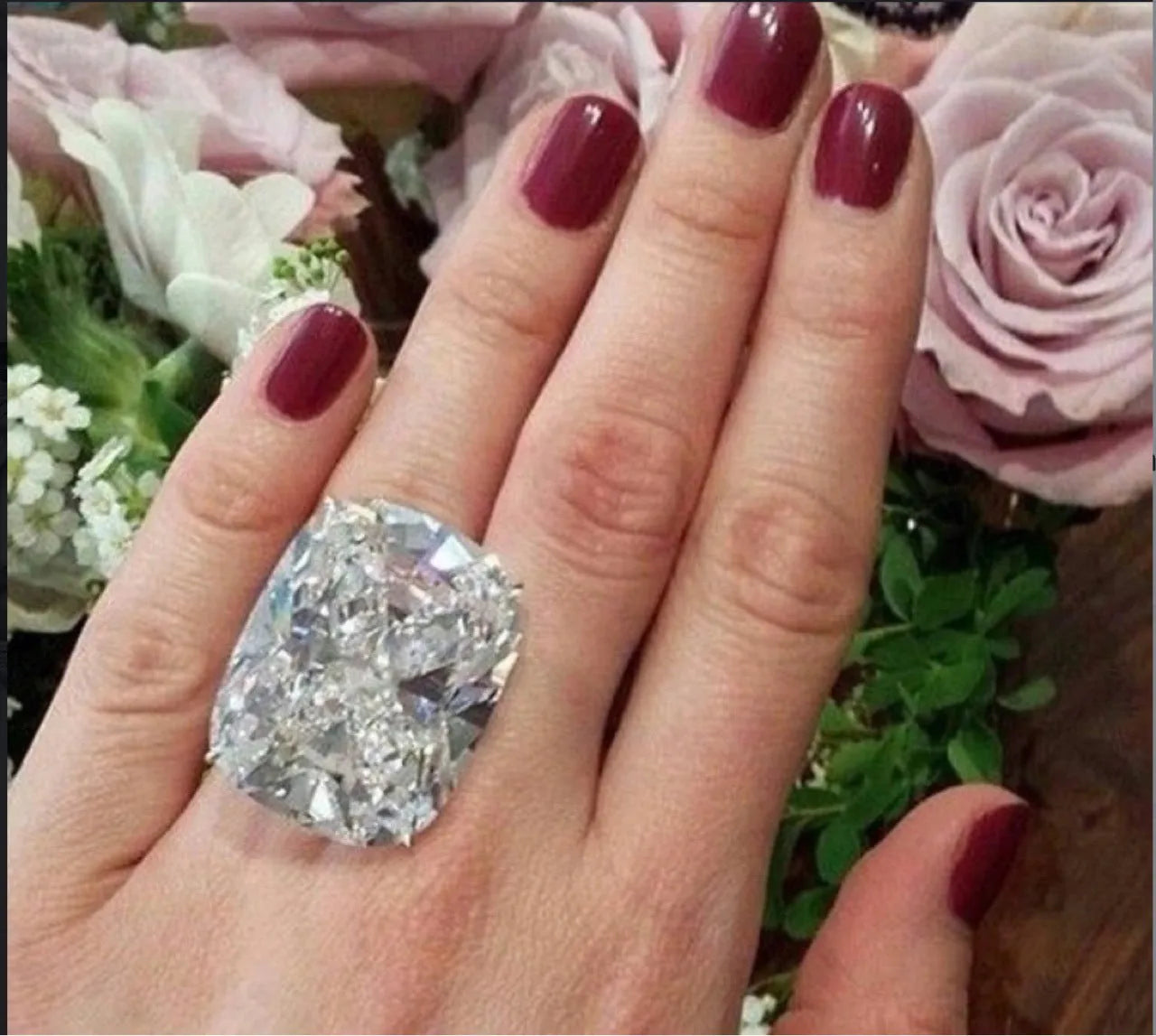A women's simple inlaid white square diamond ring with a geometric shape and white gold colour finish.