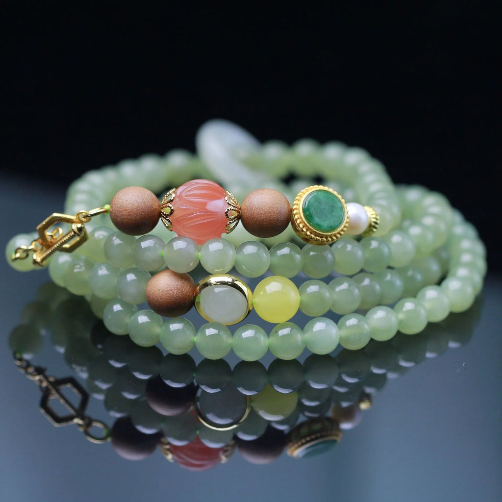 Hetian jade and sandalwood necklace with lotus beads and animal pendant, plus matching bracelet.