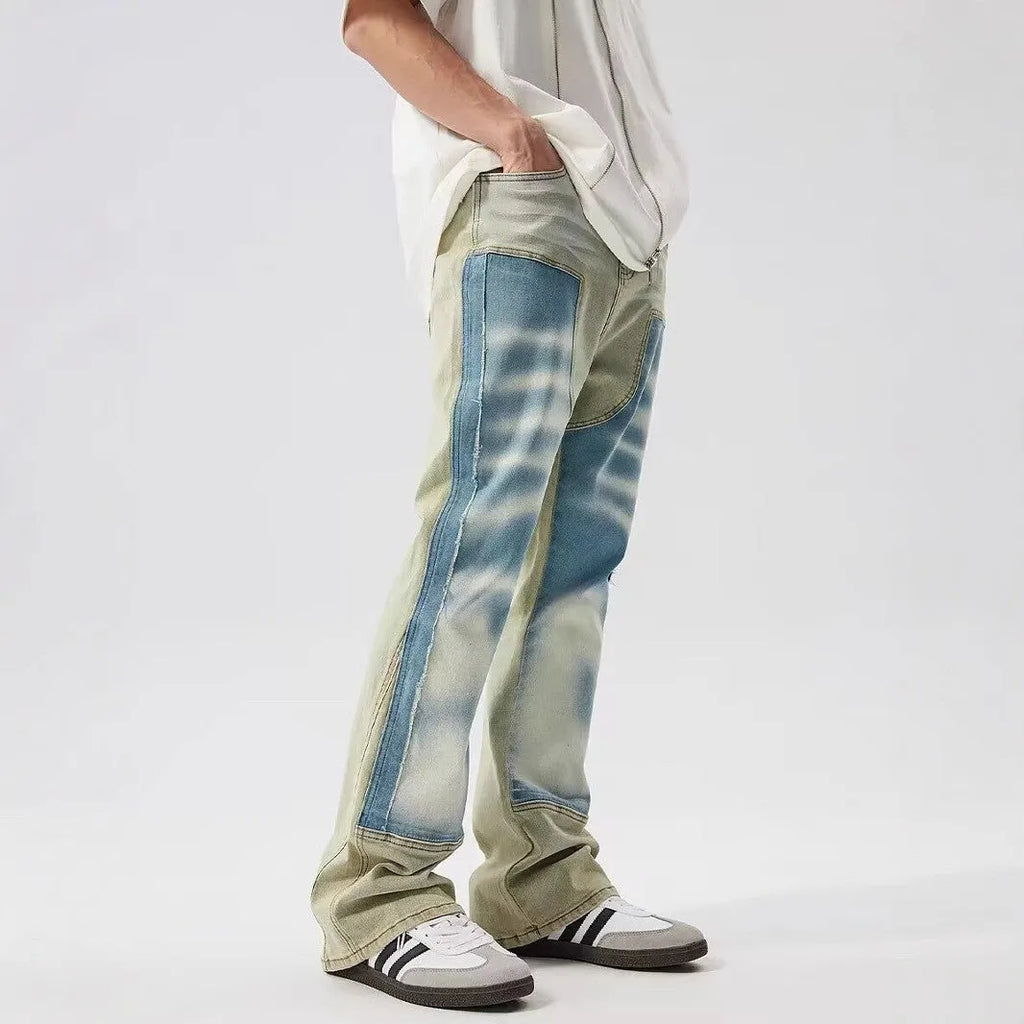 Yellow and blue retro patchwork jeans with splash-ink damaged design details on denim fabric